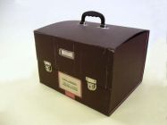 The Big Suitcase, ex. Num. 29;  34 x 29 x 41 cm, date: 2nd half of 20. century, brown cloth on carton, plastic handle, two metal locks and label; District people's committe of city Břeclav, Civil Defence;  Donated by SOkA Břeclav in Mikulov, III/2007